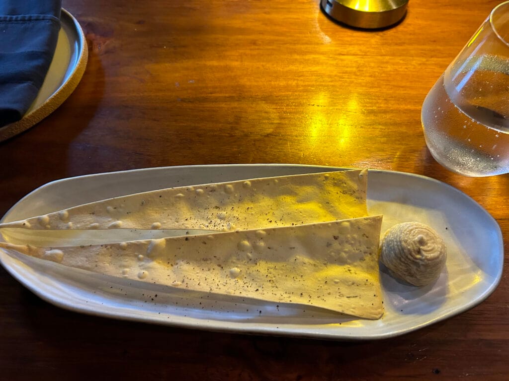 Cracker with hummus on the house